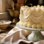 A vintage cake decorated with buttercream piping techniques and pastel colors.